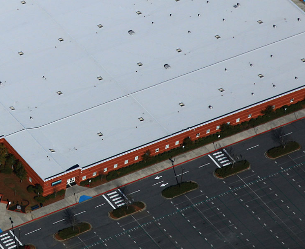 Aerial view of building roof and parking lot