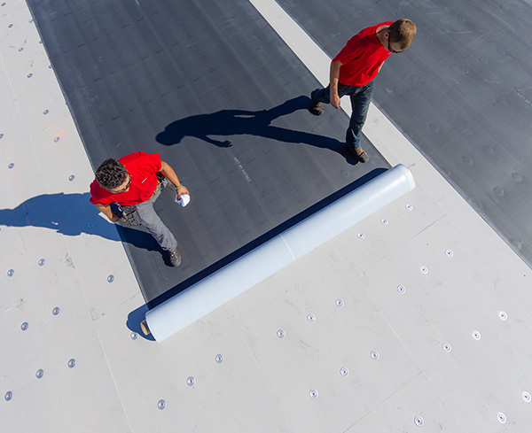 Two Contractors working on a rooftop